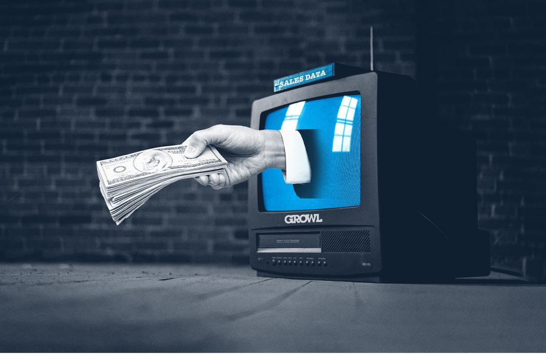 A hand holding a stack of money comes out of a tube TV, representing revenue growth after using sales data.